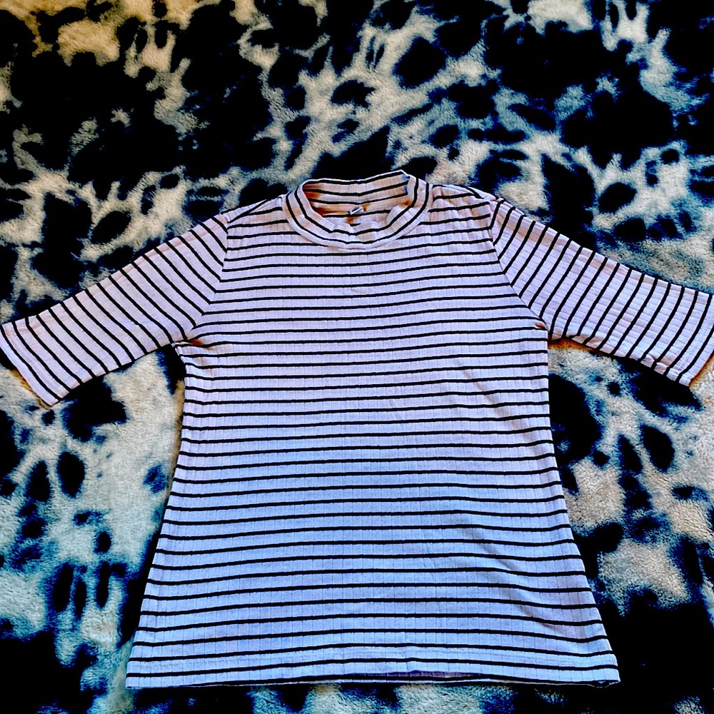 Black and white striped, fitted shirt. Made in Indonesia.